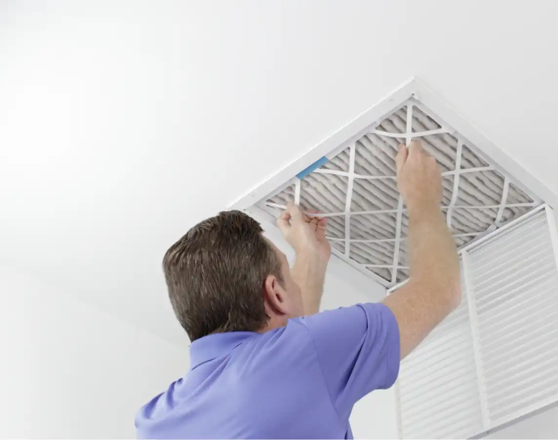 Technician performing the air duct cleaning process in a home, ensuring improved air quality and a healthier living environment. Experience professional and thorough cleaning with Frank.